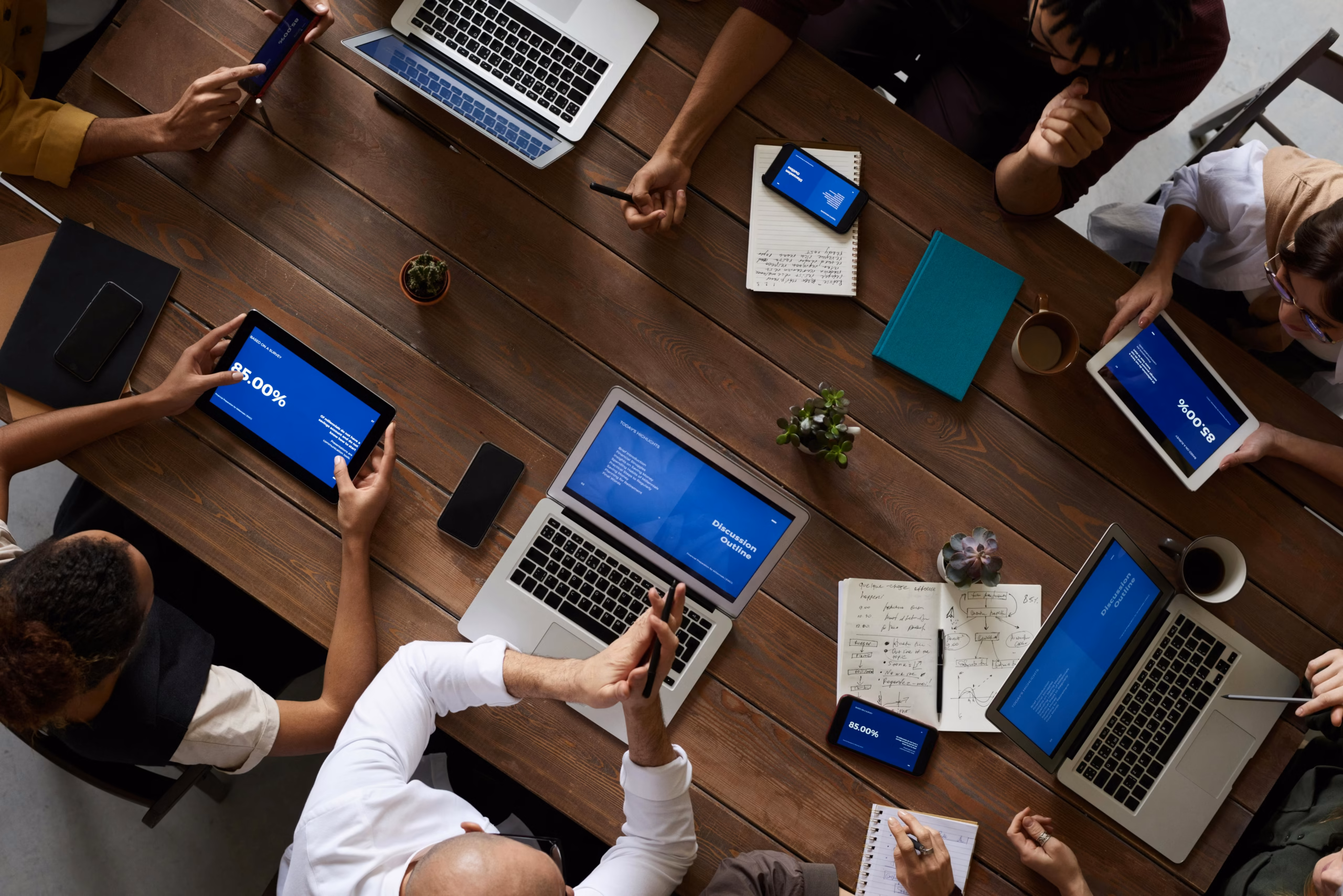 A stock photo of team of business professionals working productively in a modern high-rise office with city view